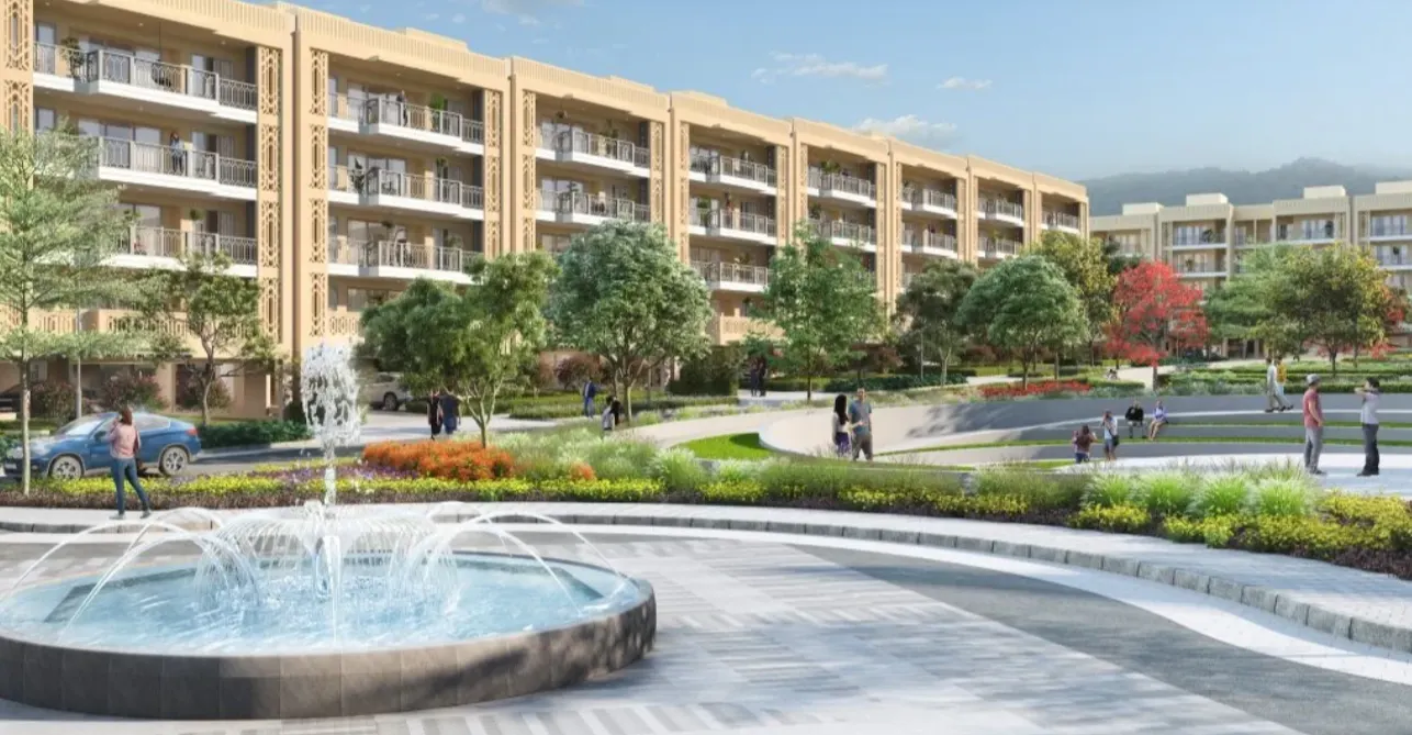 Luxury residential apartment complex with landscaped gardens, decorative fountain, pedestrian pathways, and modern balconies at The Valley Orchard.